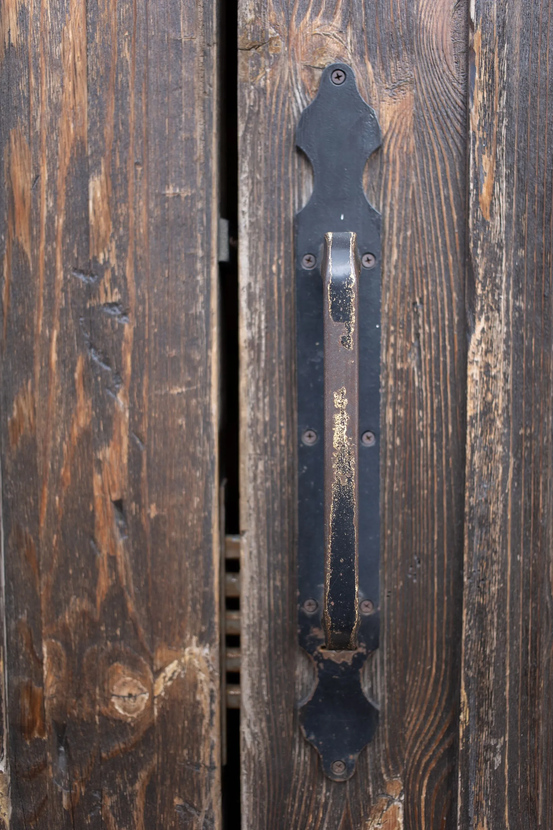 Wrought iron handle on an old wooden door