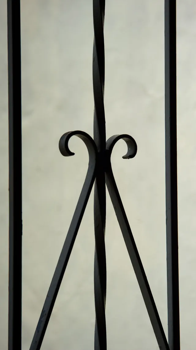 Detail of hand-forged ironwork, black double scrollwork